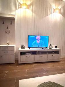 a living room with a television on a table at Baja's Garden Apartman in Bajina Bašta