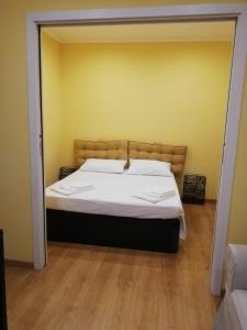 a bedroom with a large bed in a room at Candelieri Suites in Sassari
