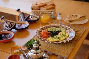 a table with a plate of food on a table at Imsouane Harmony in Imsouane