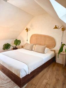 a bedroom with a large bed in a attic at Le Pré de la Mer Suite & SPA Privatif in Querqueville +41 photos