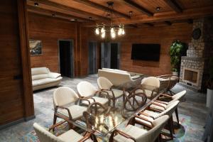 a dining room with a table and chairs and a fireplace at Fayz Mount Residence in Chimgan