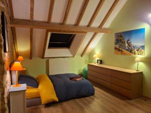 a bedroom with a bed and a dresser in a room at Au Lou Pélélée in Madranges