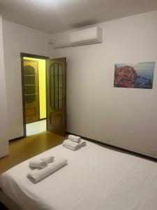 a bedroom with a bed with towels on it at La casa di RÒ in Avegno