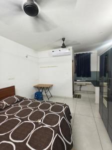 a bedroom with a bed and a table in it at K K Residency in Alwaye
