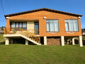 a brick house with a staircase in front of it at Datvina Panorama Chalets Mravaldzali, Racha in Oni +16 photos