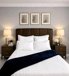 a bedroom with a large bed with two nightstands and two lamps at R&N Hosts in Maseru