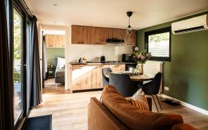 a living room and kitchen with a couch and a table at Meikever in Putten