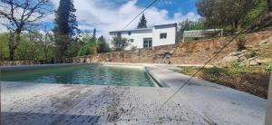 a swimming pool in front of a house at Casa en Camino del cuadrado Sierras de Córdoba in Río Ceballos