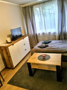 a bedroom with a bed and a table and a window at Na Podwalu in Jaworzno