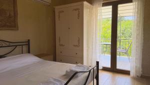 a bedroom with a bed and a door to a balcony at Kyveli Homes in Therma +20 photos