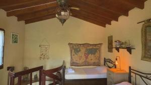 a bedroom with a bed in a room with a ceiling at Kyveli Homes in Therma