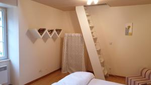 a room with a bed and stairs in a room at Gîte La Salamandre in Passenans