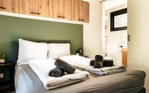 a bedroom with a bed with towels on it at Meikever in Putten