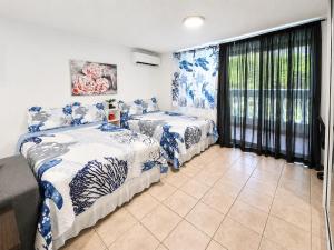 two beds in a room with a window at Golden Dream Studio 2nd floor B in Isabela +43 photos