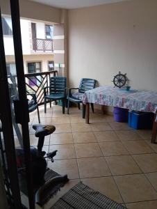 a room with a table and chairs and a table at Hibberdene See to Sea in Hibberdene +4 photos