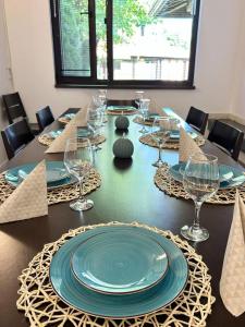 a long table with plates and wine glasses on it at Villa Foresta in Oreshak