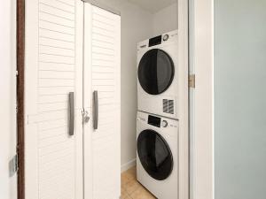 two washer and dryer cabinets in a room at Golden Dream Studio 2nd floor B in Isabela
