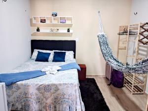 a bedroom with a bed and a hammock at Hospedagem Aconchego do Lar in Barreirinhas +13 photos