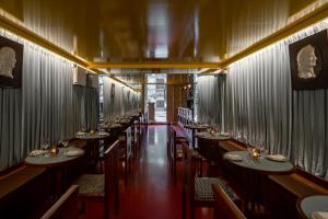 a row of tables in a restaurant with chairs at Hotel Casa Bosques Pensión in Mexico City