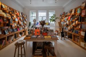 a room filled with lots of books on shelves at Hotel Casa Bosques Pensión in Mexico City +17 photos