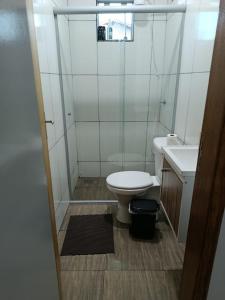 a bathroom with a toilet and a sink at Pousada Paraiso in Telêmaco Borba +6 photos