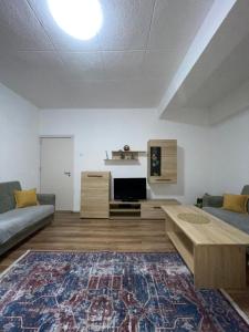 a living room with a couch and a coffee table at Bleon Apartment in Prizren