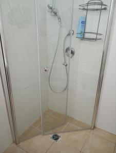 a shower stall with a glass shower door at 123Eilat panorama in Eilat +22 photos