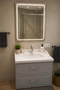 a bathroom with a sink and a mirror at EL CHORRO Aire acondicionado Bar privado Barbacoa Amplios patios in Castalla +75 photos