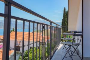 a balcony with a table and chairs and a view at Villa Bokeljka in Krašići