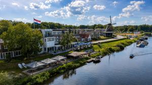 an aerial view of a river with a windmill at Hotel de Zon - Brasserie Bresson by Flow in Ommen