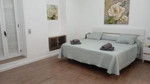 a bedroom with a bed with two pillows on it at Sunny terrace flat in Ceuta
