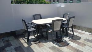 a table and chairs sitting next to a wall at Sunny terrace flat in Ceuta
