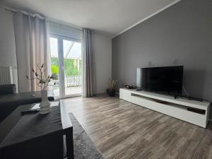 a living room with a large flat screen tv at Sweethome - Köln Messe in Bergisch Gladbach