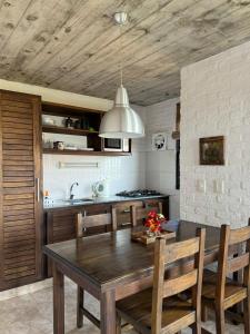 a kitchen with a wooden table and a dining room at Las Pakas in La Paloma
