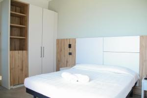 a bedroom with a bed with two towels on it at HOTEL BALTIC in Alba Adriatica +10 photos