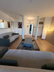 a living room with a couch and a table at El Cubanito Athéna - Résidence de Standing - 2 Chambres - 4 Couchages - 8 Personnes Max - Parking Privé - Gare à 8 min in Cergy +41 photos