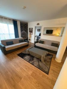 a living room with two couches and a rug at El Cubanito Athéna - Résidence de Standing - 2 Chambres - 4 Couchages - 8 Personnes Max - Parking Privé - Gare à 8 min in Cergy