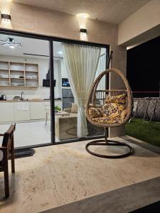 a wicker chair sitting in a living room at Modern Mountain Villa with Pool near Tbilisi in Bulach'auri +15 photos