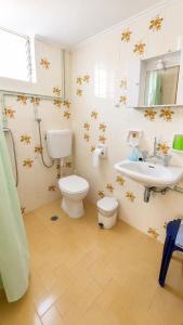 a bathroom with a toilet and a sink at Pension Vienna in Methana +19 photos