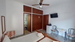a living room with a couch and a ceiling fan at Pension Vienna in Methana