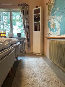 a bedroom with a bed and a window with wine bottles at Skolan - Boende Vindelälven in Gargnäs