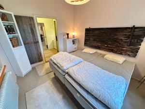 a bedroom with a bed with a large headboard at Skolan - Boende Vindelälven in Gargnäs