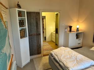 a bedroom with a bed and a door to a bathroom at Skolan - Boende Vindelälven in Gargnäs