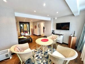 a living room with a table and chairs at Le Saint July in Eauze