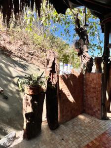 a fence with two wooden logs and a plant at Casa Alma in Sayulita +1 photo