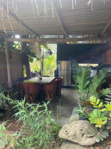 a patio with a table and some plants at Casa Alma in Sayulita