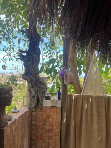 a fence with a palm tree in the background at Casa Alma in Sayulita