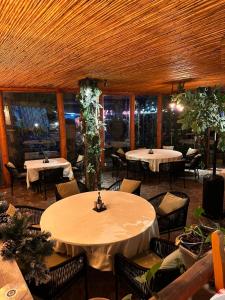 a restaurant with two tables and chairs in a room at Dajti Alpin Villas in Tirana
