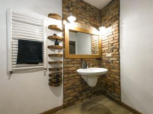 a bathroom with a sink and a mirror at Dom pod strzechą in Swornegacie +15 photos