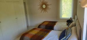 a bedroom with two beds and a mirror on the wall at Villa Cañicosa in Cañícosa +2 photos